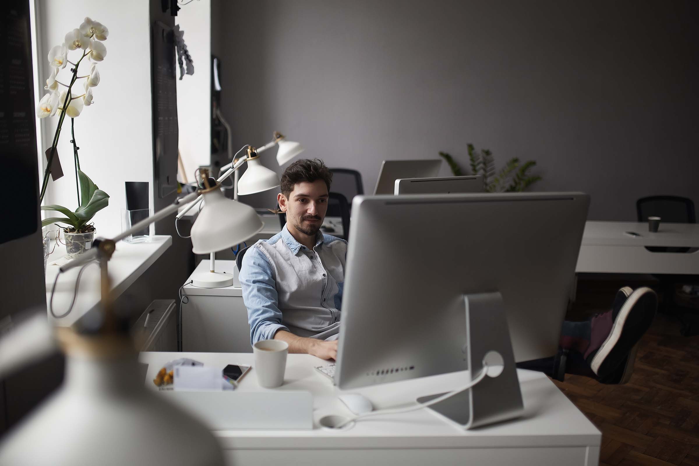 young-intelligent-bearded-man-working-at-modern-lo-ZMWRQLS.jpg